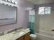 A full bathroom features a vanity with a granite countertop, a bathtub, and a shower at 14642 Williams St, Thornton, CO 80602