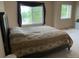 Spacious bedroom featuring bright windows with dark curtains, neutral walls, and carpeted flooring at 14642 Williams St, Thornton, CO 80602