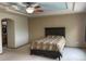 Large primary bedroom features a decorative tray ceiling, neutral walls, and carpeted flooring at 14642 Williams St, Thornton, CO 80602