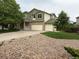 Charming two-story home featuring a three-car garage, well-kept lawn, and mature trees in a suburban setting at 14642 Williams St, Thornton, CO 80602