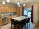 Bright kitchen features a breakfast bar with pendant lighting and access to the patio at 14642 Williams St, Thornton, CO 80602