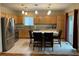 Bright kitchen features a stainless steel refrigerator, breakfast bar, and recessed lighting at 14642 Williams St, Thornton, CO 80602