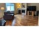 Spacious living area with hardwood floors, a fireplace, and plenty of natural light at 14642 Williams St, Thornton, CO 80602