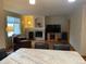 Open-concept living space with a fireplace, television, and hardwood flooring at 14642 Williams St, Thornton, CO 80602