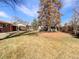 Large fenced backyard with mature trees and shed at 3268 S Patton Ct, Denver, CO 80236