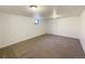 Unfinished basement featuring carpet flooring and a small window at 3268 S Patton Ct, Denver, CO 80236