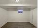 Spacious unfinished basement with carpet flooring and small window at 3268 S Patton Ct, Denver, CO 80236