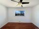 Bedroom with hardwood floors, neutral decor, and a bright window at 3268 S Patton Ct, Denver, CO 80236