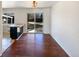 Bright dining area with wood floors and sliding glass door to the backyard at 3268 S Patton Ct, Denver, CO 80236