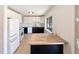 Well-lit kitchen featuring stainless steel appliances and white cabinets at 3268 S Patton Ct, Denver, CO 80236