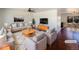 Bright living room with modern furnishings and an open layout connected to the dining area at 3268 S Patton Ct, Denver, CO 80236