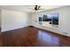 Bright living room featuring hardwood floors and a large window overlooking the street at 3268 S Patton Ct, Denver, CO 80236