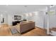 Finished basement area with sleek wood floors, modern lighting, couch, and wall mounted television at 3520 Newton St, Denver, CO 80211