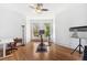 Spacious bedroom with natural light, hardwood floors, and a ceiling fan, set up as a home gym and office at 3520 Newton St, Denver, CO 80211