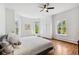 Bright bedroom featuring wood floors, white walls, and several large windows for ample light at 3520 Newton St, Denver, CO 80211