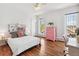 Bright bedroom with a ceiling fan, hardwood floors, a pink dresser, and a writing desk at 3520 Newton St, Denver, CO 80211
