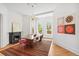 Dining room with chandelier, fireplace, hardwood floors, colorful rug, and modern artwork at 3520 Newton St, Denver, CO 80211