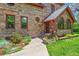 Close up of the front of a stone house with charming architectural features and landscaping at 3520 Newton St, Denver, CO 80211
