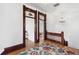 Hallway with wood trim, hardwood floors, and a decorative rug at 3520 Newton St, Denver, CO 80211