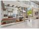 Bright kitchen featuring white cabinets, marble countertops, a wood island, and stainless steel appliances at 3520 Newton St, Denver, CO 80211