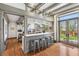 Open kitchen with stainless steel appliances, a breakfast bar, hardwood floors, and ample natural light at 3520 Newton St, Denver, CO 80211