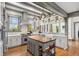 Bright kitchen featuring white cabinets, marble countertops, a wood island, and stainless steel appliances at 3520 Newton St, Denver, CO 80211