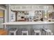 Modern kitchen featuring a breakfast bar with seating, stainless steel appliances, and bright lighting at 3520 Newton St, Denver, CO 80211