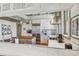 Bright kitchen featuring white cabinets, marble countertops, a wood island, and stainless steel appliances at 3520 Newton St, Denver, CO 80211
