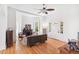 Open concept living room with a fireplace, hardwood floors, and a bright entry at 3520 Newton St, Denver, CO 80211