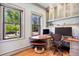 A bright and airy office space with two windows and built-in shelving with a sleek desk at 3520 Newton St, Denver, CO 80211