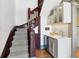 Staircase with wood accents and a built-in bar with beverage fridge and sink at 3520 Newton St, Denver, CO 80211
