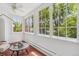 Sunroom featuring large windows, tile floors, and a small table with charming plant decor at 3520 Newton St, Denver, CO 80211