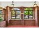 Bright sunroom with brick walls, arched windows, and natural light at 3520 Newton St, Denver, CO 80211