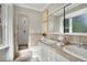 Bright bathroom with tiled walls, double sinks, and glass enclosed shower at 2290 E Columbia Pl, Denver, CO 80210