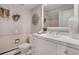 Clean bathroom featuring a stylish vanity, mirror, and decorative plants at 2290 E Columbia Pl, Denver, CO 80210