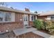 Close-up view of the home's front porch featuring a white door with glass and brick detailing at 2290 E Columbia Pl, Denver, CO 80210