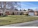 Charming single-story home boasts a well-maintained lawn, mature trees, and attached two-car garage at 2290 E Columbia Pl, Denver, CO 80210