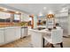 Modern kitchen featuring stainless steel appliances, white cabinets and countertops, and a central island with seating at 2290 E Columbia Pl, Denver, CO 80210