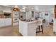 Modern kitchen with a center island, stainless appliances, and a view of the living area at 2290 E Columbia Pl, Denver, CO 80210