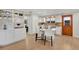Bright kitchen featuring an island with white countertops and seating, stainless steel appliances, and light hardwood floors at 2290 E Columbia Pl, Denver, CO 80210