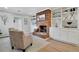 Cozy living room featuring a brick fireplace, built-in shelving, and hardwood floors at 2290 E Columbia Pl, Denver, CO 80210