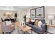 Well-decorated living room showcasing a comfortable sofa, decorative pillows, and a view of the dining area at 2290 E Columbia Pl, Denver, CO 80210