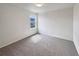 Bedroom featuring neutral carpet, white walls, and window with neighborhood views at 4670 Quandary Peak St, Brighton, CO 80601