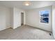 Bedroom featuring neutral carpet, closet, white walls, and window with neighborhood views at 4670 Quandary Peak St, Brighton, CO 80601