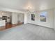 Bright living room featuring neutral carpet, white walls, and windows with neighborhood views at 4670 Quandary Peak St, Brighton, CO 80601