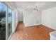 Open living room features hardwood floors, natural light from sliding glass doors, and modern light fixture at 4670 Quandary Peak St, Brighton, CO 80601