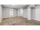 Large basement space featuring carpeting, neutral paint, and multiple entrances at 118 S Yates Way, Denver, CO 80219