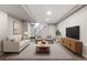 Finished basement with a couch, two chairs, TV and staircase at 118 S Yates Way, Denver, CO 80219