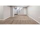 Spacious basement area featuring carpeting, a staircase, and neutral-colored walls at 118 S Yates Way, Denver, CO 80219