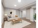 Cozy basement living area featuring modern furniture, decor, and neutral carpet, for comfortable living at 118 S Yates Way, Denver, CO 80219